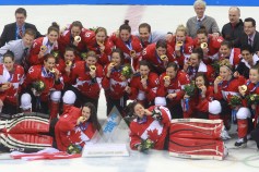 Team Canada celebrates beating Team USA in the gold medal women's hockey match
