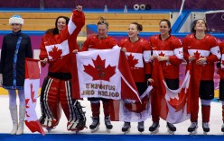 Team Canada celebrates beating Team USA in the gold medal women's hockey match