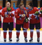 Team Canada celebrates beating Team USA in the gold medal women's hockey match
