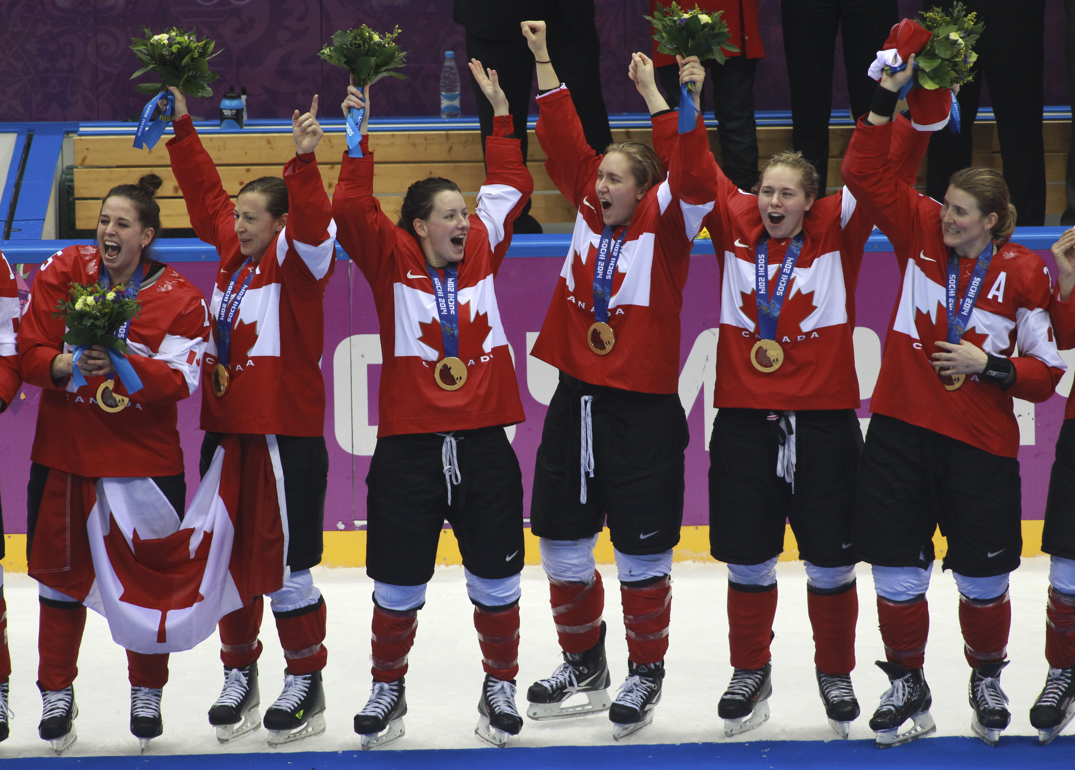 Team Canada celebrates beating Team USA in the gold medal women's hockey match