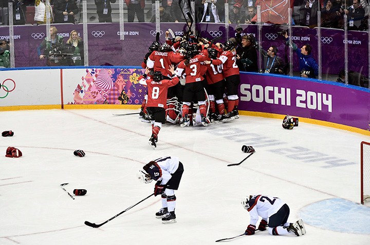Team Canada celebrates beating Team USA in the gold medal women's hockey match
