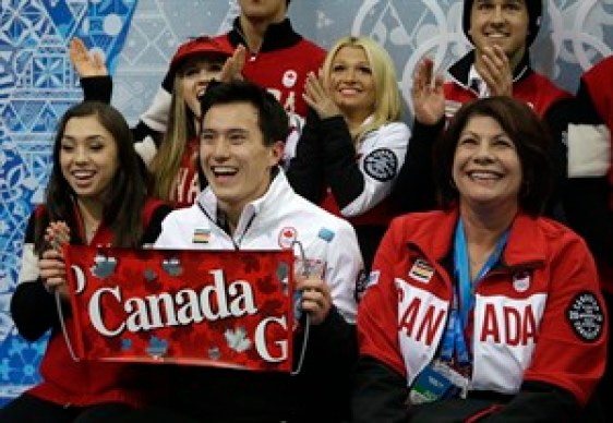 Patrick Chan of Canada, centre, and his team members wait for his results after he competed in the men's team short program figure skating competition at the Iceberg Skating Palace during the 2014 Winter Olympics, Thursday, Feb. 6, 2014, in Sochi, Russia. (AP Photo/Darron Cummings, Pool)