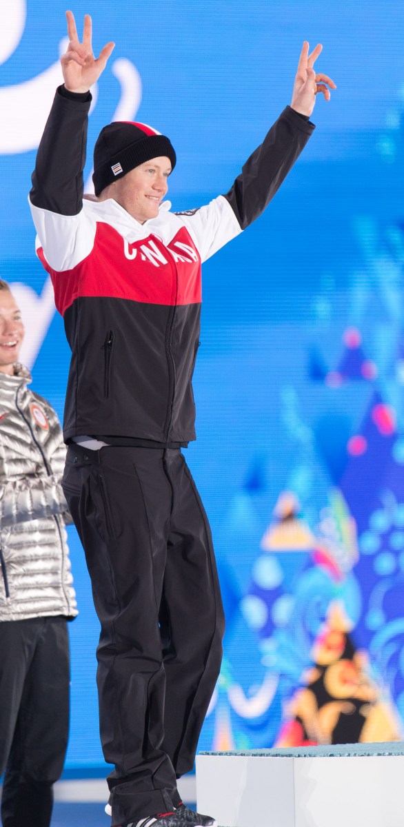 Mike Riddle receives the silver medal in men's ski halfpipe at the 2014 Sochi Winter Olympics