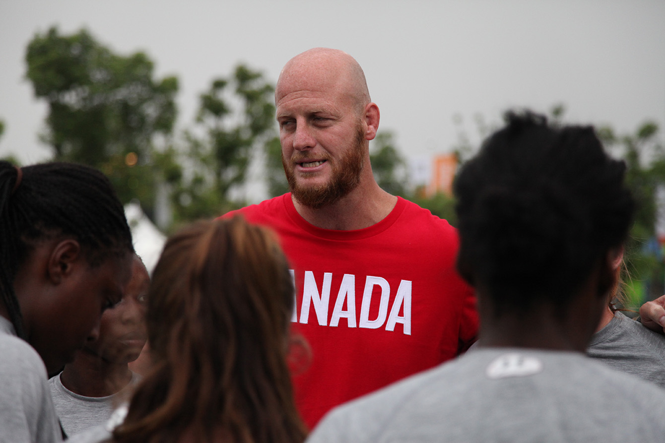 Coach John Tait addresses his team