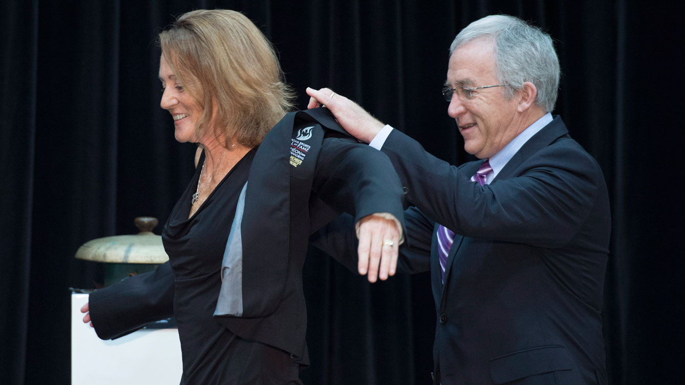 Geraldine Heaney receives her Hall jacket from Colin MacDonald, chair of Canada's Sports Hall of Fame board of governors.