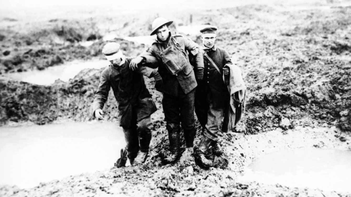 From Canadian Press: 1917 file photo, wounded Canadian and German World War One soldiers help one another through the mud during the Battle of Passchendaele in Passchendaele, Belgium. 