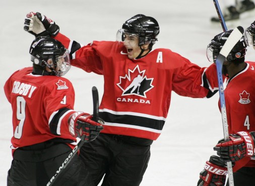 Patrice Bergeron, centre, celebrates a goal with teammates Sidney Crosby, left, and Shawn Belle (Photo: CP)