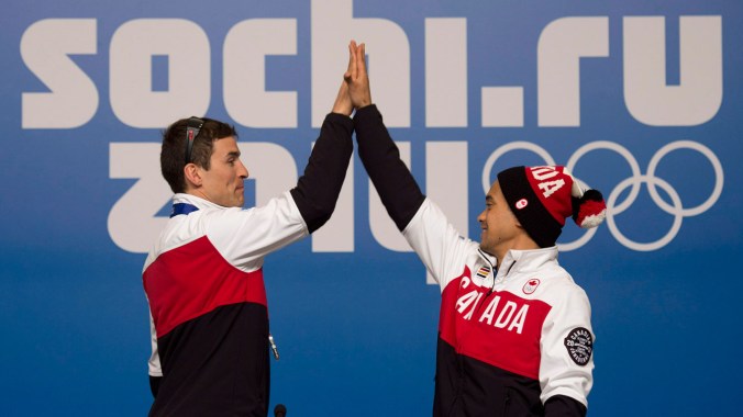 Morrison & Junio - Sochi 2014 Denny Morrison (left) and Gilmore Junio high-five at Sochi's Main Press Centre.