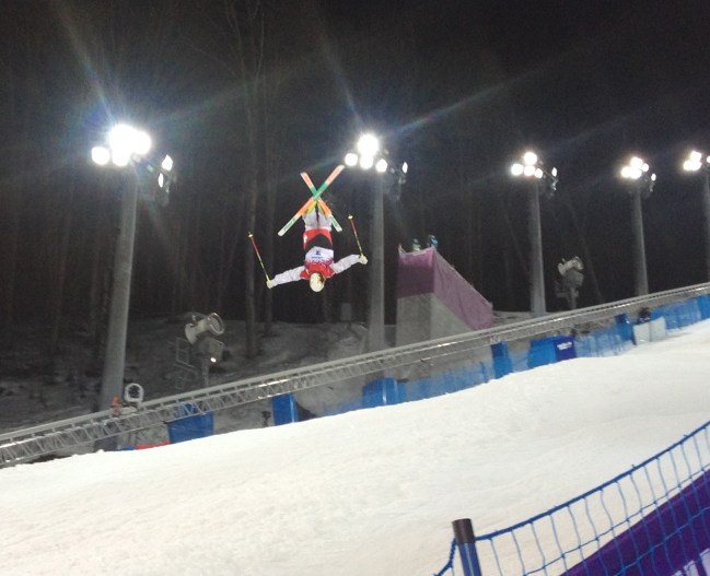 Sideline view of the final jump at the 2014 Sochi women's moguls event at Rosa Khutor Extreme Park. Feb 8, 2014. Photo : Steve Boudreau