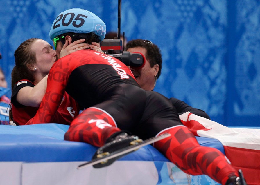 Charles Hamelin and girlfriend Marianne St-Gelais celebrate.