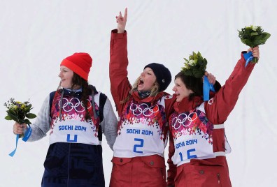 Dara Howell (L) and Kim Lamarre (R) celebrate their gold and bronze medals during the flower ceremony for ski slopestyle.