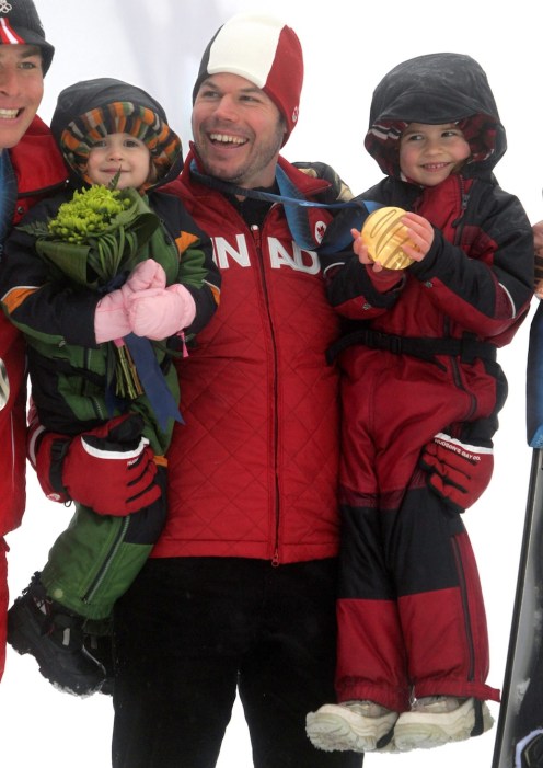 Canada's Jasey-Jay Anderson holds his daughters Jy, left, and Jora, right, as she holds his gold medal after he won the men's parallel giant slalom snowboard final at the Vancouver Winter Olympics at Cypress Mountain in West Vancouver, B.C., on Saturday February 27, 2010. THE CANADIAN PRESS/Darryl Dyck