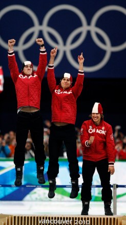 Canadian speed skaters Denny Morrison, left, Lucas Makowsky and Mathieu Giroux, right, celebrate their gold medal in the men's team pursuit long track speed skating race Saturday February 27, 2010 the 2010 Vancouver Olympic Winter Games in Vancouver. THE CANADIAN PRESS/Robert Skinner