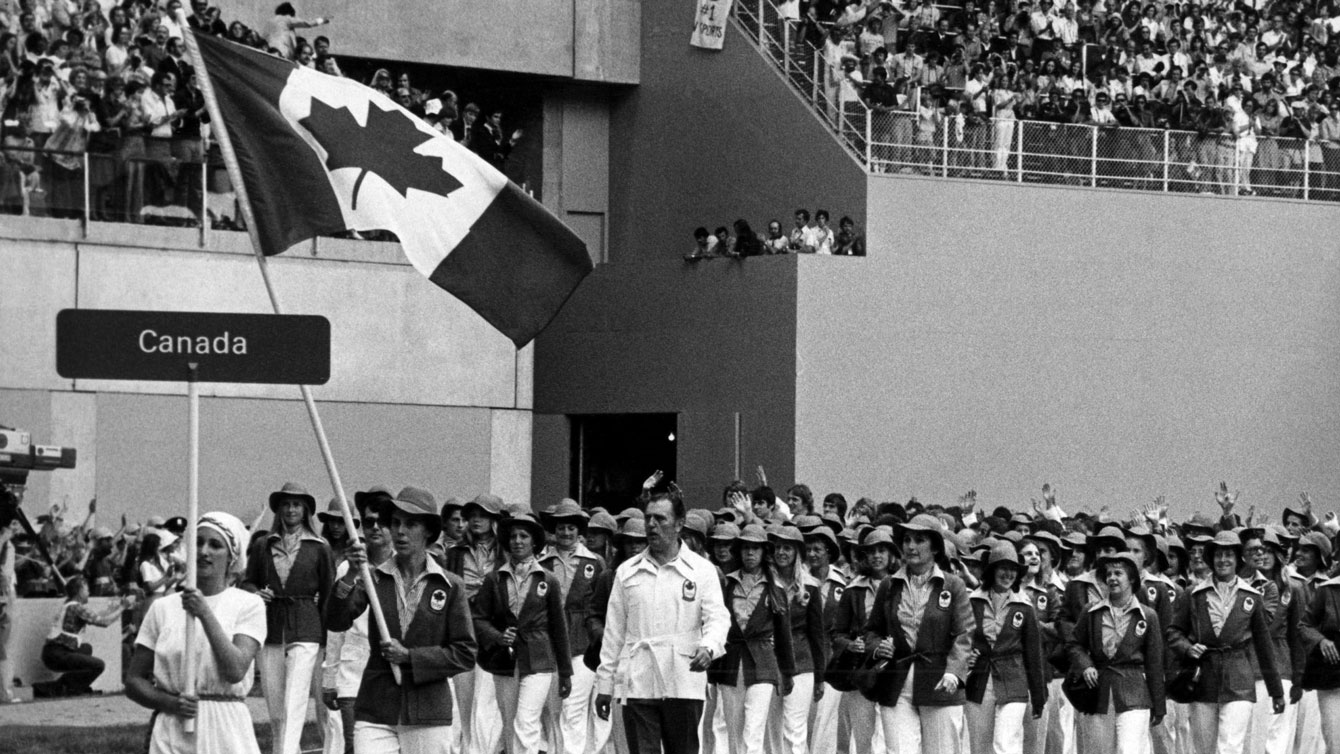 Abby Hoffman carries the Canadian flag into Olympic Stadium at Montreal 1976.