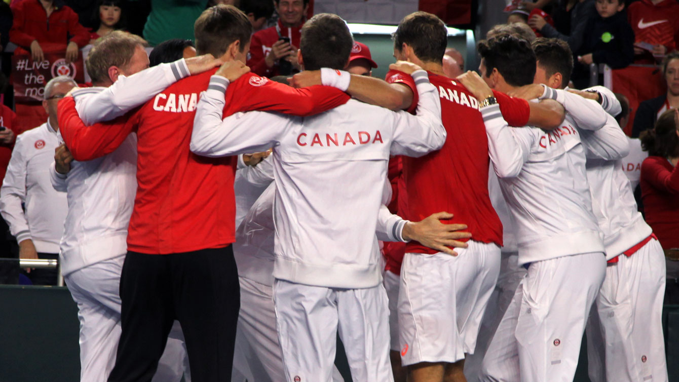Canadian team of Milos Raonic, Vasek Pospisil, Daniel Nestor and Frank Dancevic celebrate the win over Japan with coaches and some team staff.