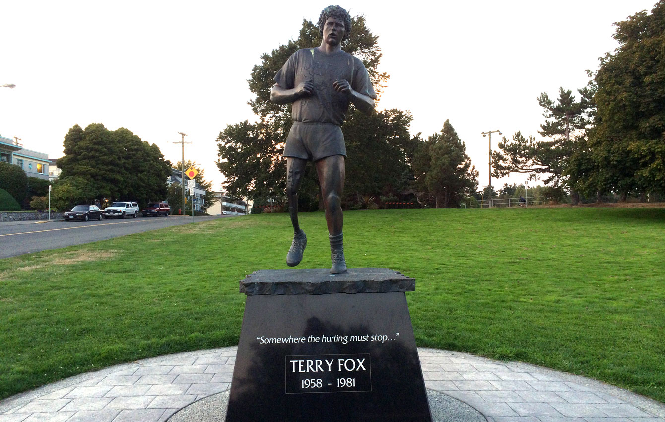 Terry Fox statue in Victoria, BC steps from the Pacific Ocean with the inscription "Somewhere the hurting must stop..." Fox would have ended his Marathon of Hope on the Pacific Ocean after starting from the Atlantic.