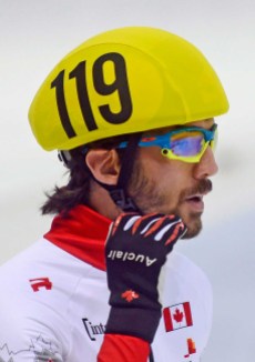 hamelin-4- Olympic champion Charles Hamelin of Canada gestures after the men's 1,500 meters preliminaries at the World Cup short track speed skating championship in Dresden, Germany, Friday, Feb. 6, 2015. The ISU World Cup runs from Feb. 6 to Feb. 8. 2015. (AP Photo/Jens Meyer)