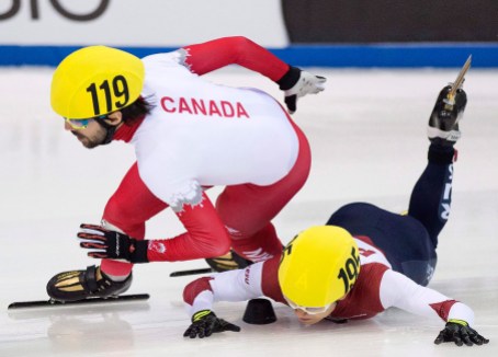 hameline-2- Olympic champion Victor An of Russia, right, crashes beside Olympic champion Charles Hamelin of Canada, left, during the men's 1,000 meters semi final race at the World Cup short track speed skating championship in Dresden, Germany, Saturday, Feb. 7, 2015. (AP Photo/Jens Meyer)