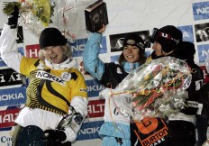 Winner Mellie Francon from Switzerland, centre, celebrates on the podium with Canadian athletes second placed Dominique Maltais, left, and third placed Maëlle Ricker, right, after the women's World Cup snowboard cross race in Bad Gastein, Austria, on Thursday, Jan.5, 2006. (AP Photo / Andreas Schaad)