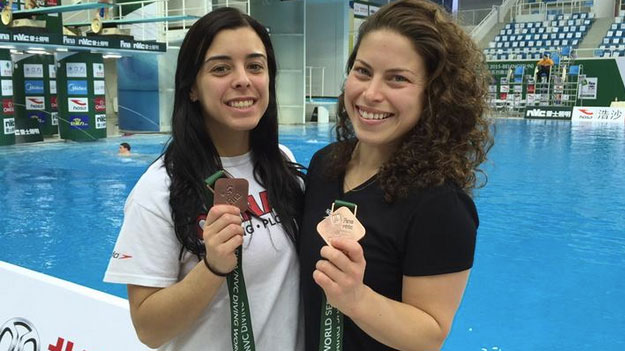 Meaghan Benfeito and Roseline Filion with their medals in Beijing (photo via @Aaron_Dziver on Twitter).