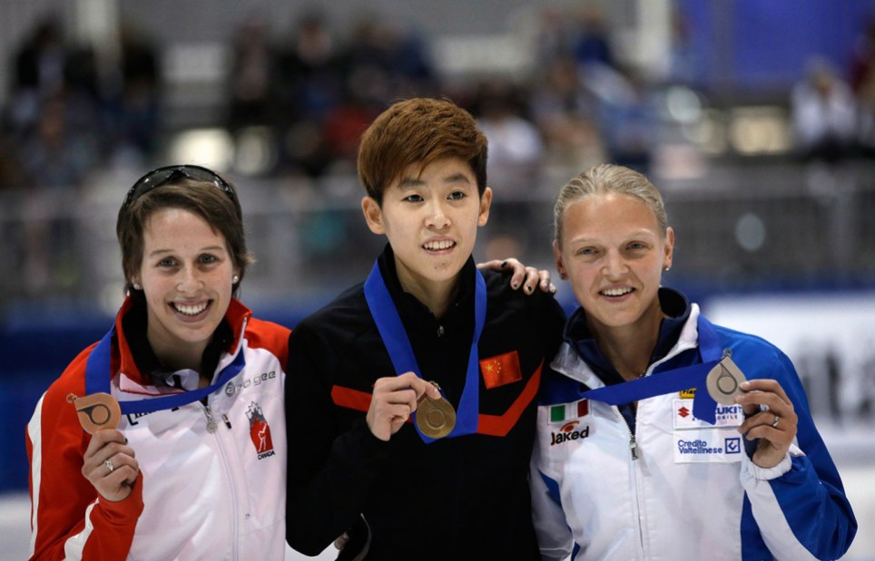 st-gelais-4- First-place finisher Fan Kexin Fan, center, of China; second-place Arianna Fontana, right, of Italy; and third-place Marianne St-Gelais, left, of Canada, celebrate with their medals following the women's 500 meters at the World Cup short track speedskating event Sunday, Nov. 9, 2014, in Kearns, Utah. (AP Photo/Rick Bowmer)