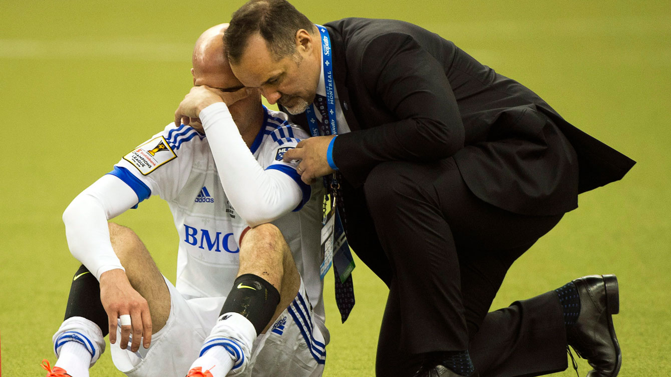Laurent Ciman of Montreal consoled by team owner Joey Saputo after Champions League final loss on April 29, 2015.