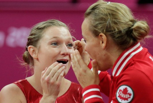 Rosie MacLennan, Karen Cockburn Rosie MacLennan and Karen Cockburn react as gold medal scores arrive at London 2012.