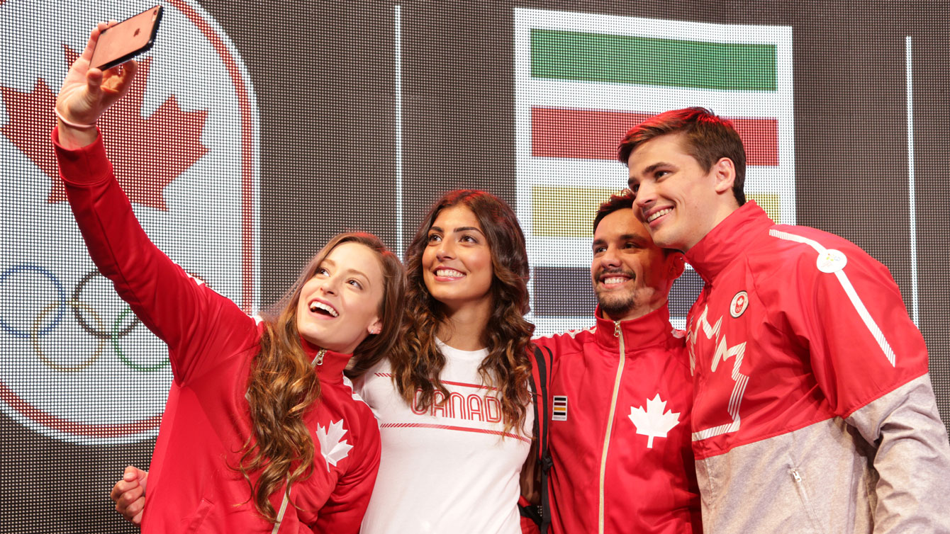 (L-R) Katerine Savard (swimming), Bianca Farella (rugby), Sergio Pessoa (judo) and Tory Nyhaug (BMX cycling) take a selfie at the Pan Am collection launch wearing a few of the Games' outfits.