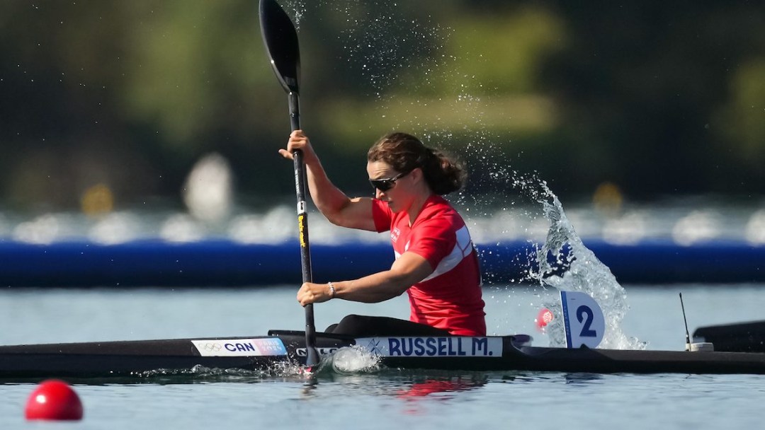 Michelle Russell races while wearing a red jersey