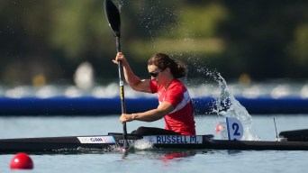 Michelle Russell races while wearing a red jersey