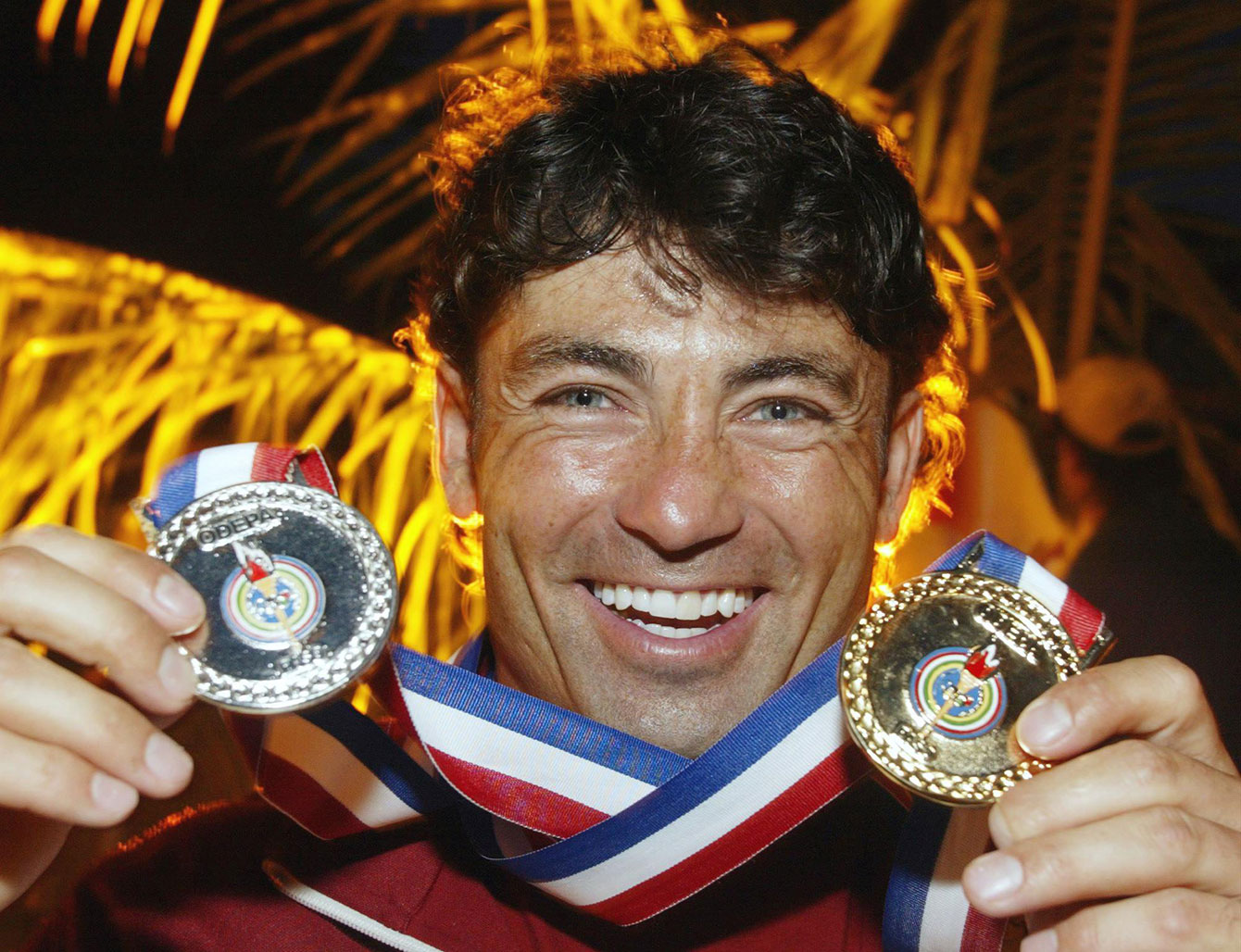 Water skier Jaret Llewellyn holds up his two Pan Am medals from Santo Domingo 2003. 