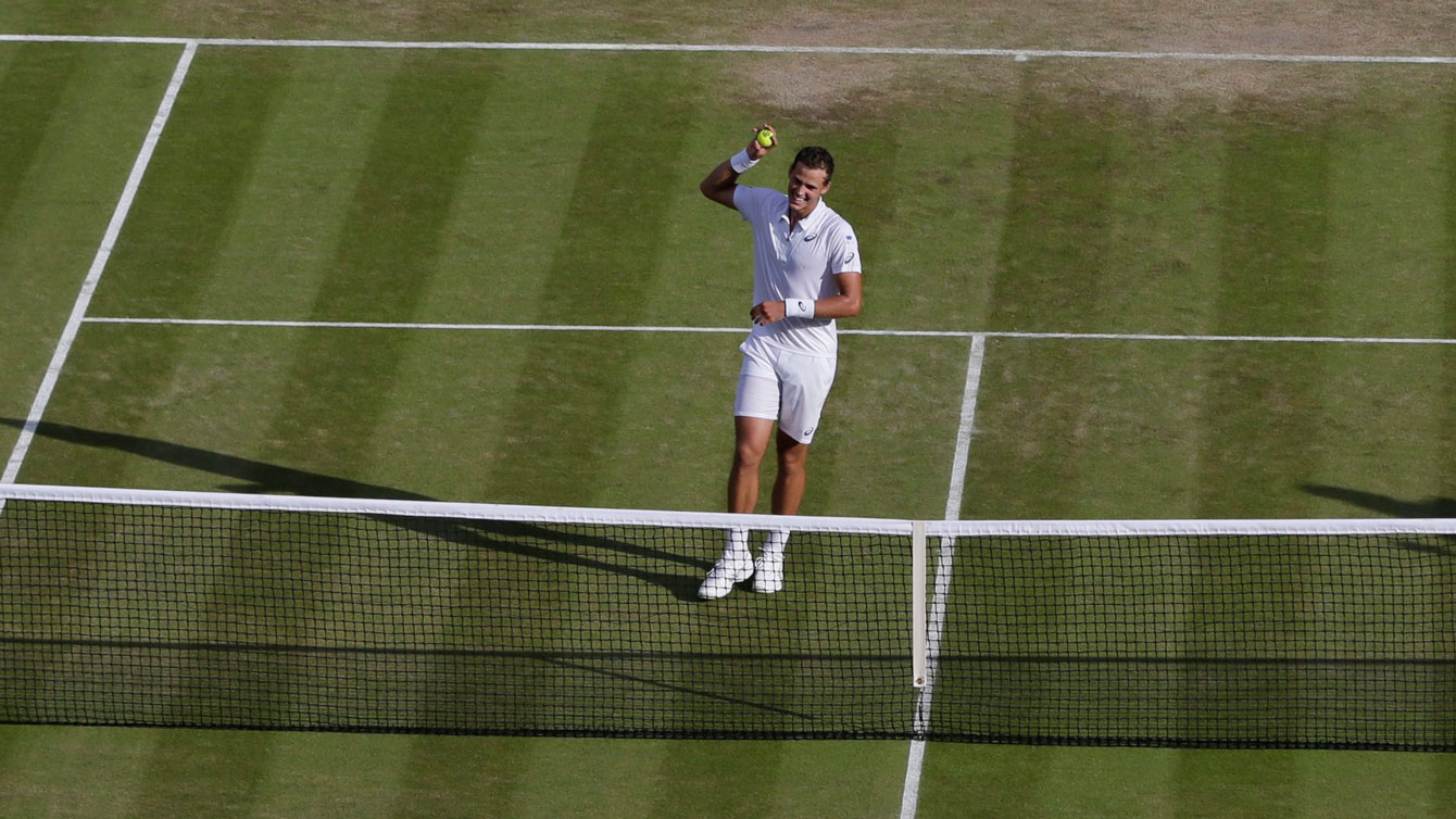 Vasek Pospisil celebrates at the net after defeating James Ward of Great Britain at Wimbledon on July 4, 2015.