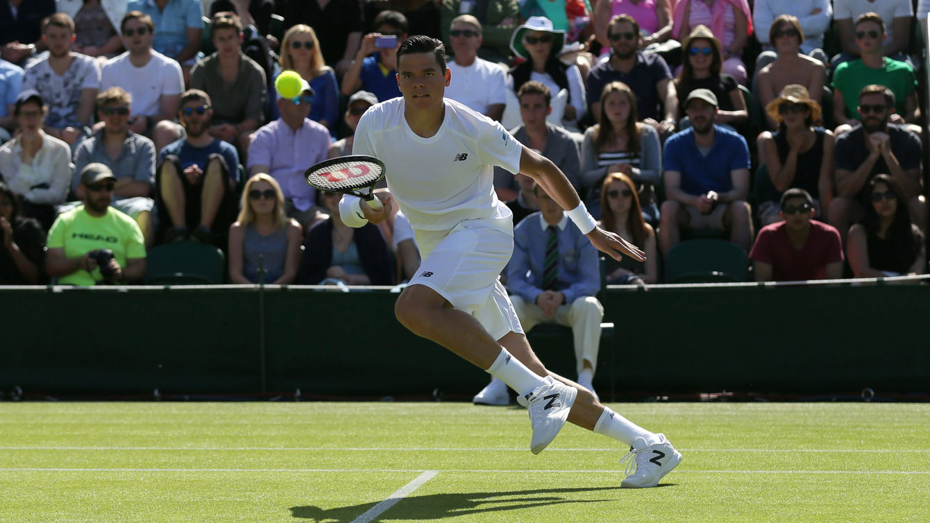 Milos Raonic chases down a ball against Daniel Gimeno-Traver of Spain at Wimbledon on June 29, 2015.