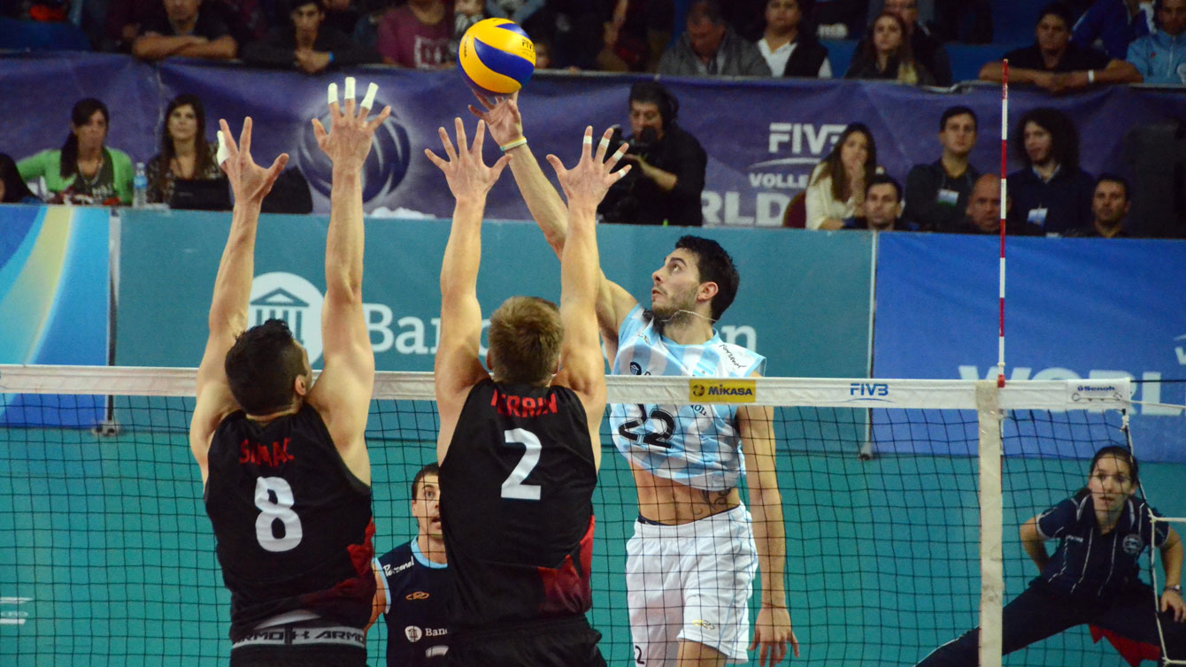 Adam Simac and Gord Perrin get up to block an Argentina hit on Saturday, June 27, 2015 (Photo: FIVB).