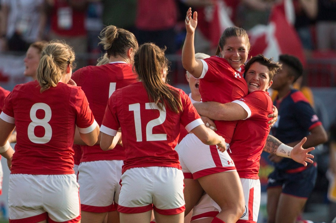 The women gather to celebrate their 55-7 gold medal match trouncing of the USA. Brittany Benn (right), Ashley Steacy (second from right). (Photo: Canadian Press)