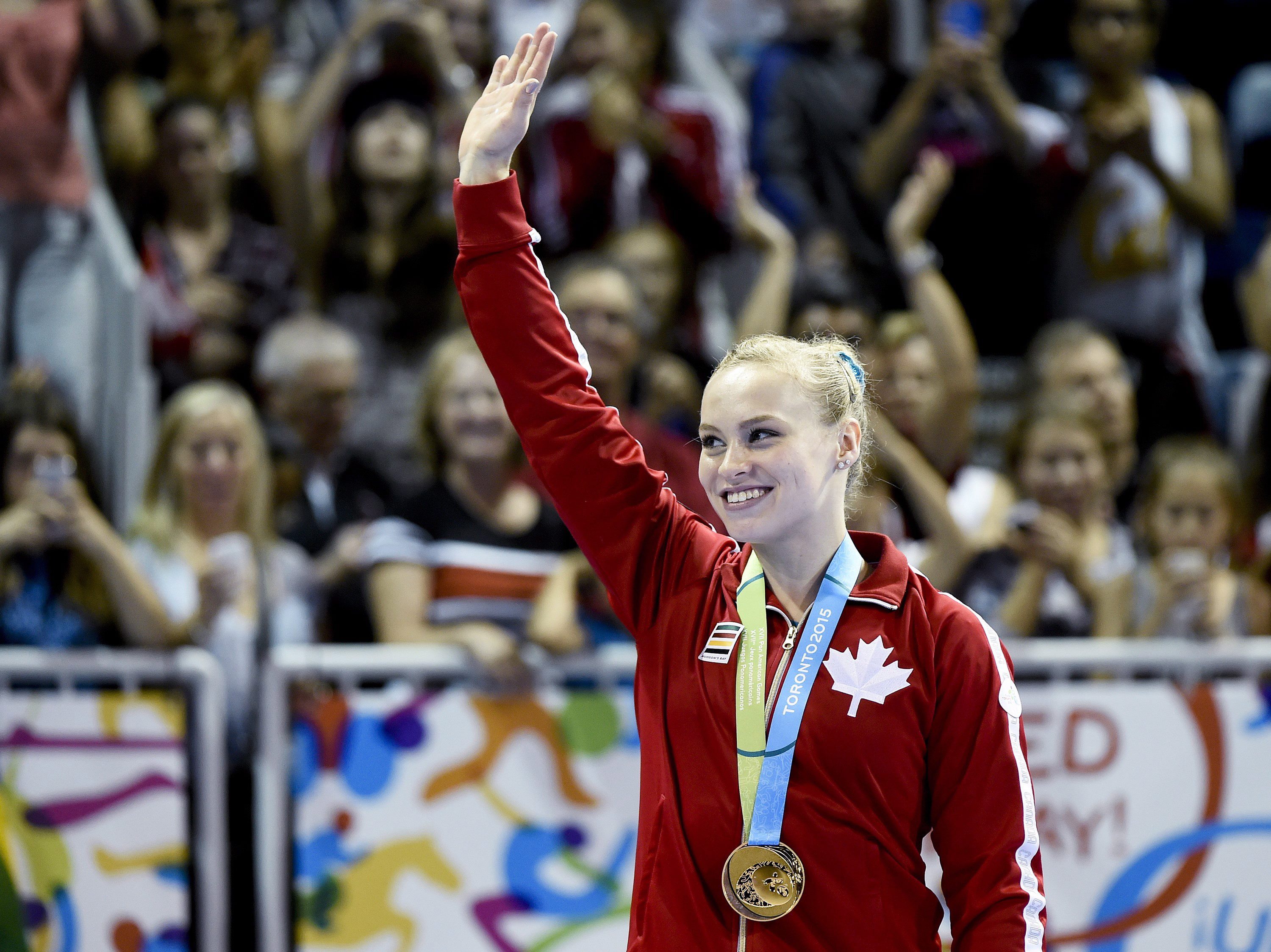Canada's Ellie Black shows off her gold medal at the women's artistic all around gymnastics competition during the Pan American Games in Toronto on Monday, July 13, 2015. THE CANADIAN PRESS/Nathan Denette