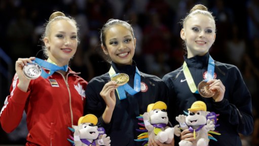 Laura Zeng, Patricia Bezzoubenko, Jasmine Kerber The United States' Laura Zeng, center, stands with Canada's Patricia Bezzoubenko, left, and the United States' Jasmine Kerber after winning the gold medal during rhythmic gymnastics clubs competition
