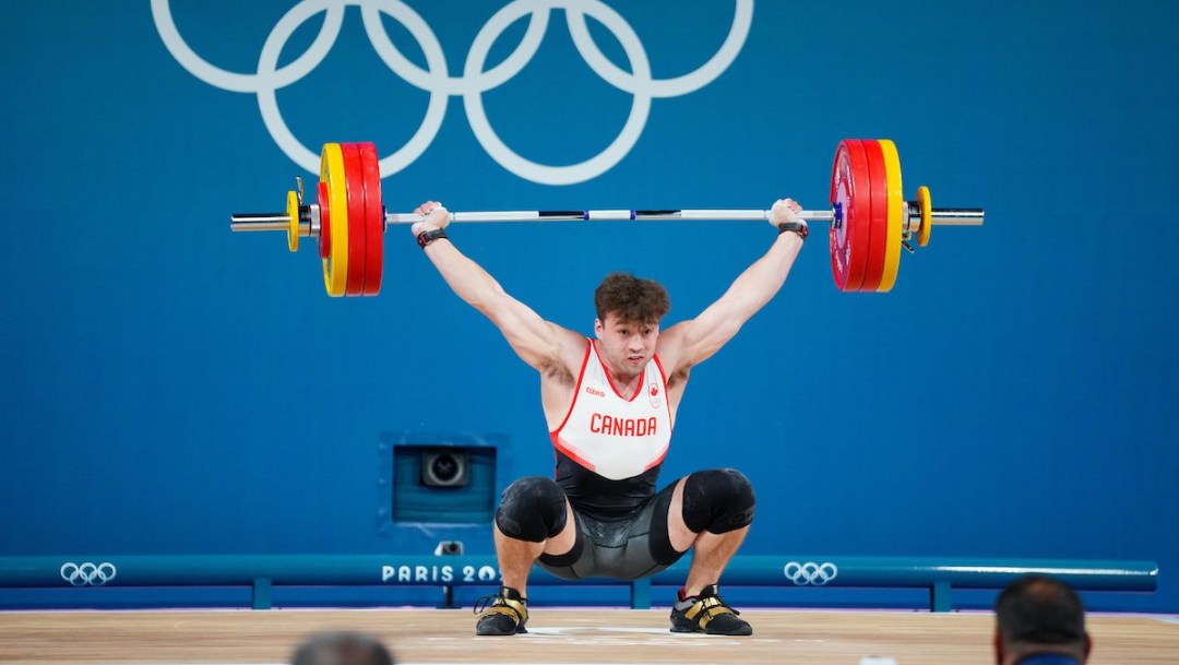 Boady Santavy lifts a barbell over his head