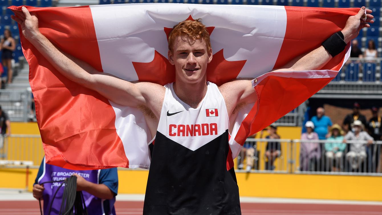 Shawn Barber celebrates with the Canadian flag after winning Pan Am Games pole vault competition on July 21, 2015. 