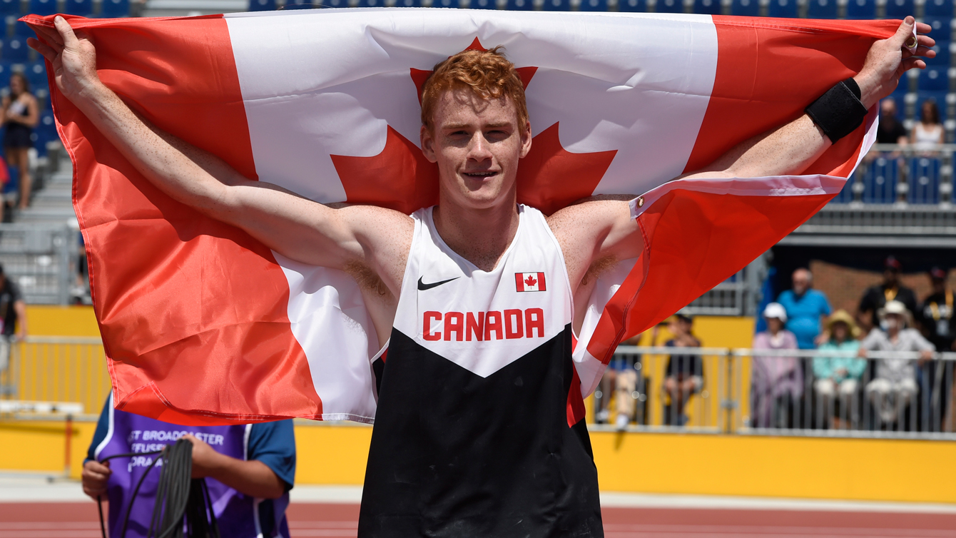 Shawn Barber celebrates with the Canadian flag after winning Pan Am Games pole vault competition on July 21, 2015.