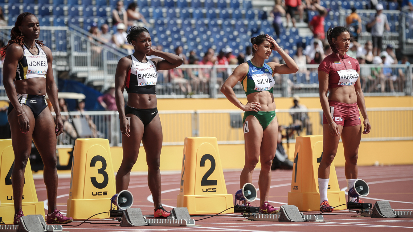 Khamica Bingham (second from left) sets up at the blocks for 100m quarterfinals of the Pan Am Games on July 21, 2015.