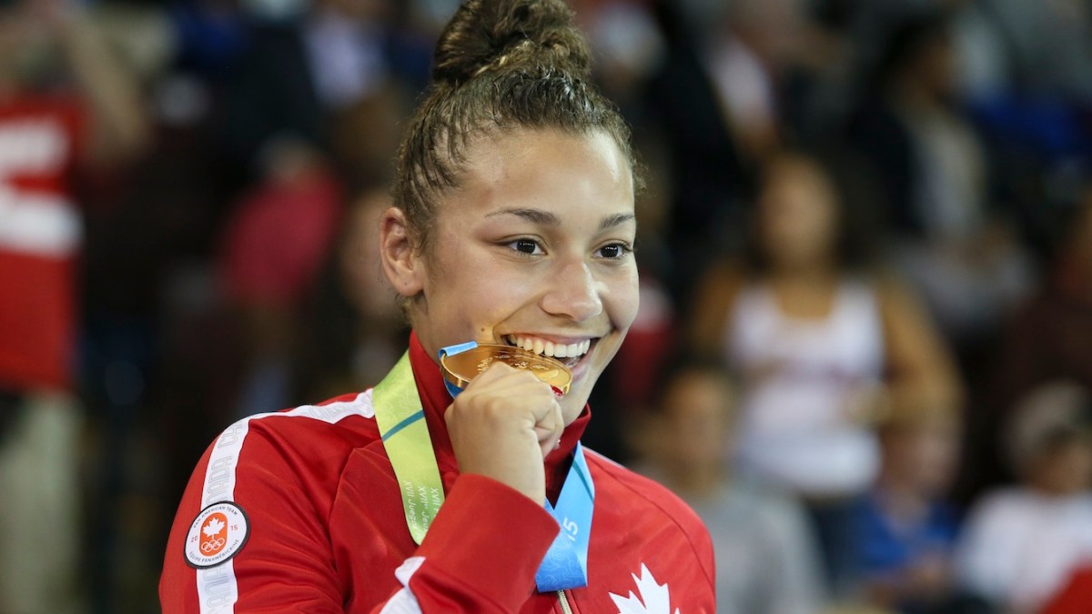 Braxton Stone-Papadopoulos biting her medal