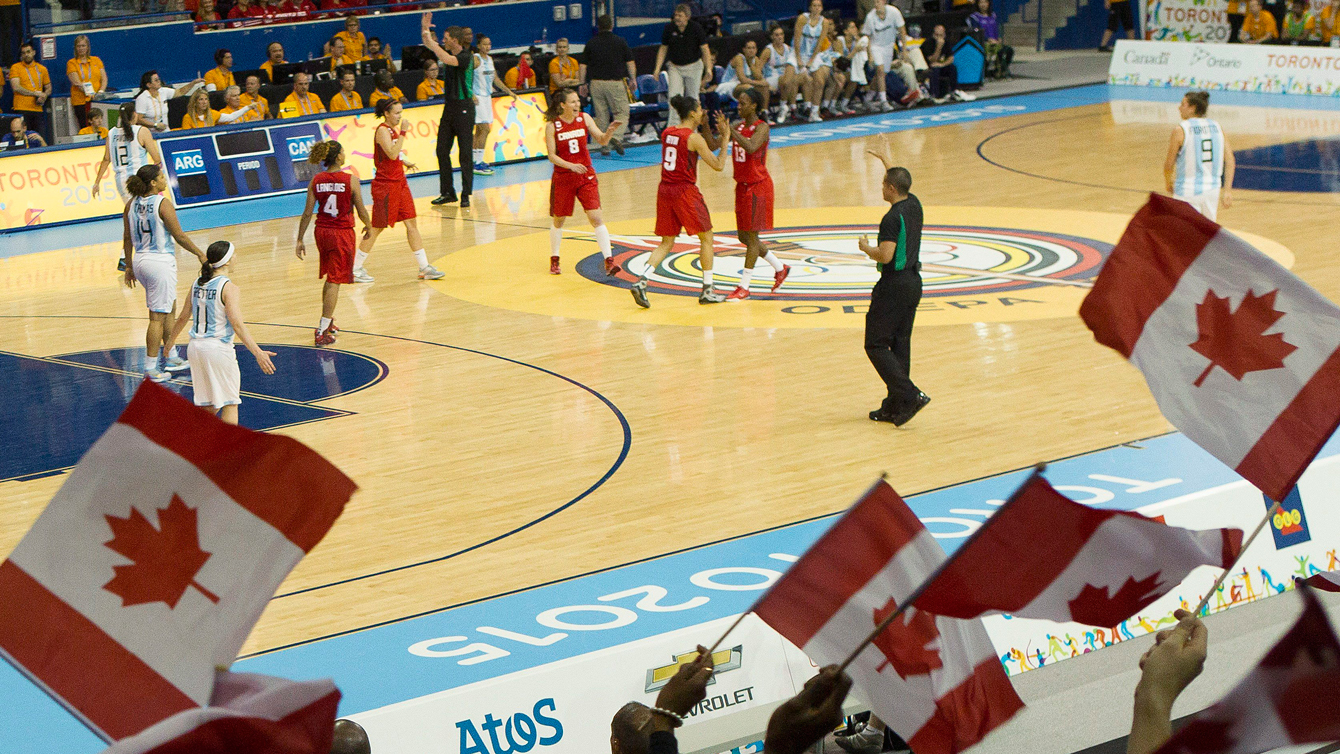 Canada fans wave the maple leaf in a Toronto 2015 Pan American Games women's basketball game against Argentina.
