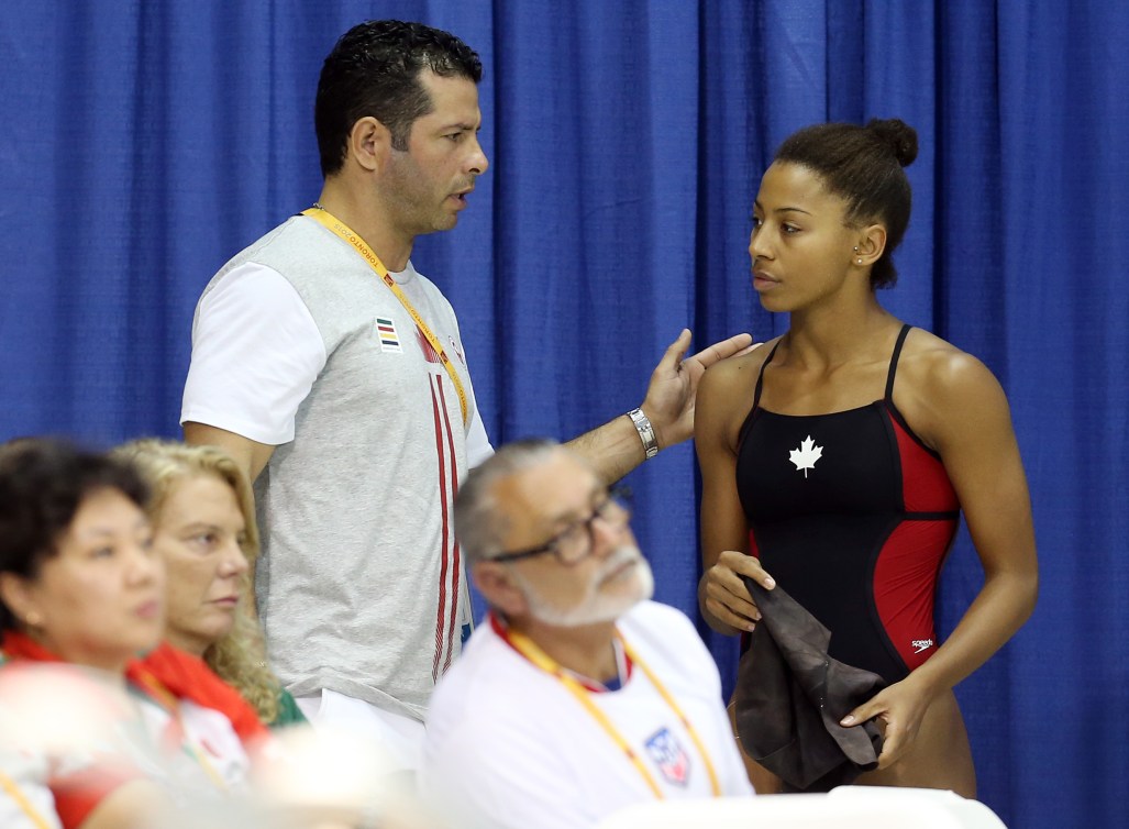 TORONTO, ON - JULY 12: Jennifer Abel of Canada speaks to her coach Arturo Miranda as she competes in the Women's 3m Springboard Prelims during the Toronto 2015 Pan Am Games at the CIBC Aquatic Centre on July 12, 2015 in Toronto, Ontario, Canada. (Photo by Vaughn Ridley/Canada Diving)