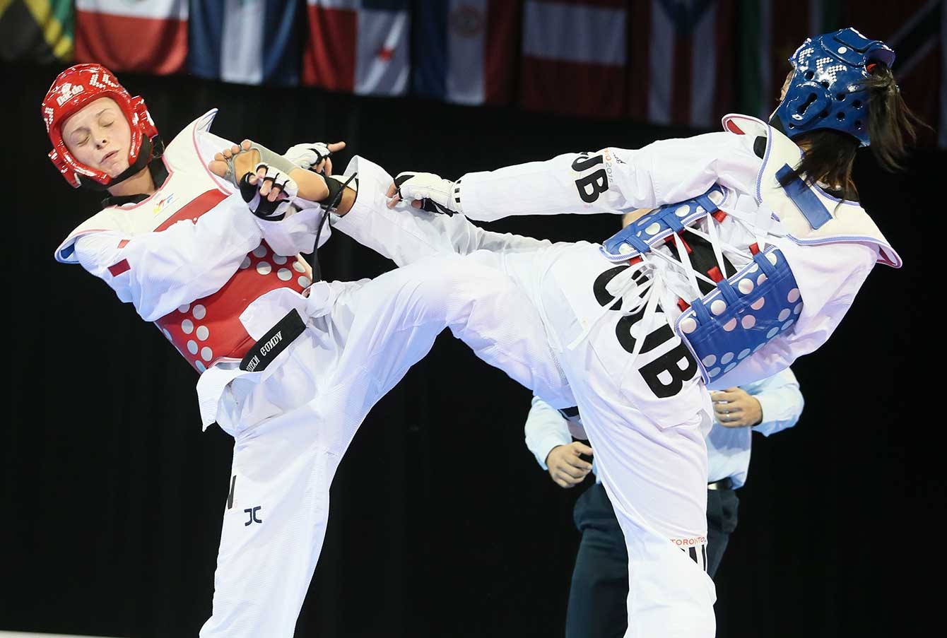 Yamicel Nunez delivers a kick during her bronze medal fight with Canada's Evelyn Gonda.
