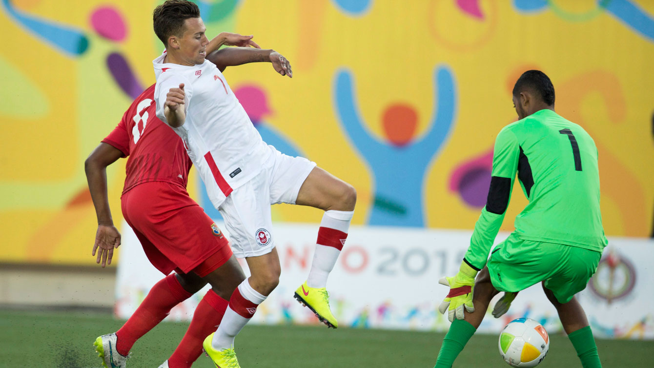 Ben Fisk of Canada (in white) tries to score against Panama in Pan Am Games football on July 16, 2015.