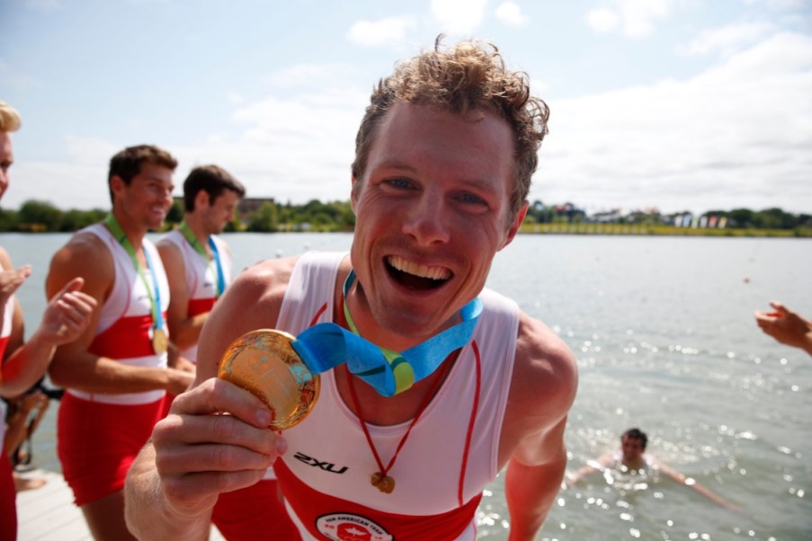 Canada's Men's Eight Team (Rowing) Will Dean shows off his gold medal