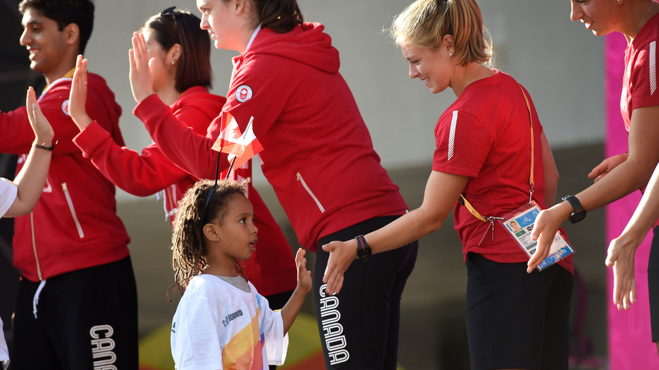 Team Canada athletes meet a young admirer at Nathan Phillips Square (Jason Ransom/COC). 