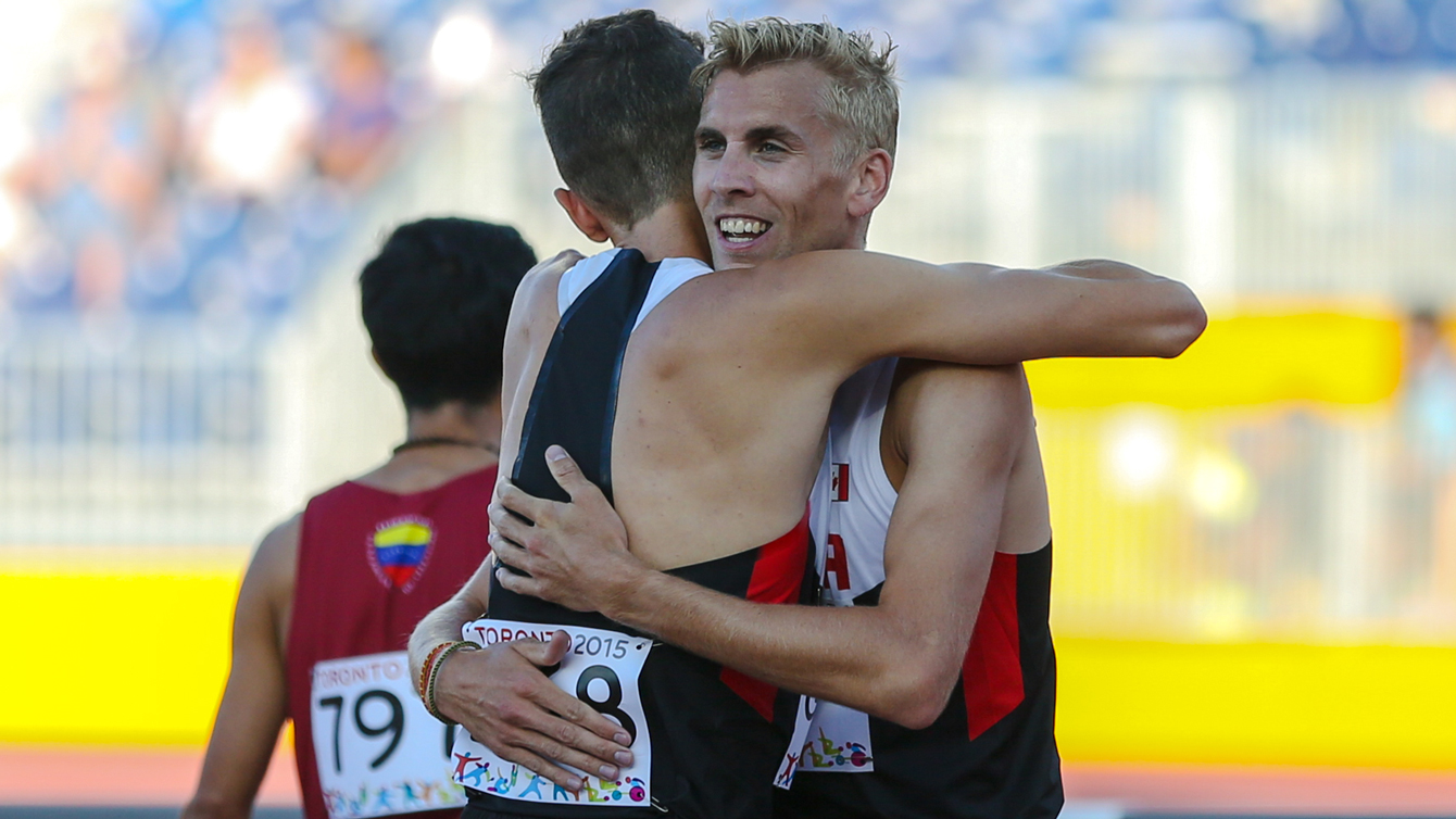 Matt Hughes and Alex Genest embrace after finishing 1-2 in Pan Am Games steeplechase on July 21, 2015.