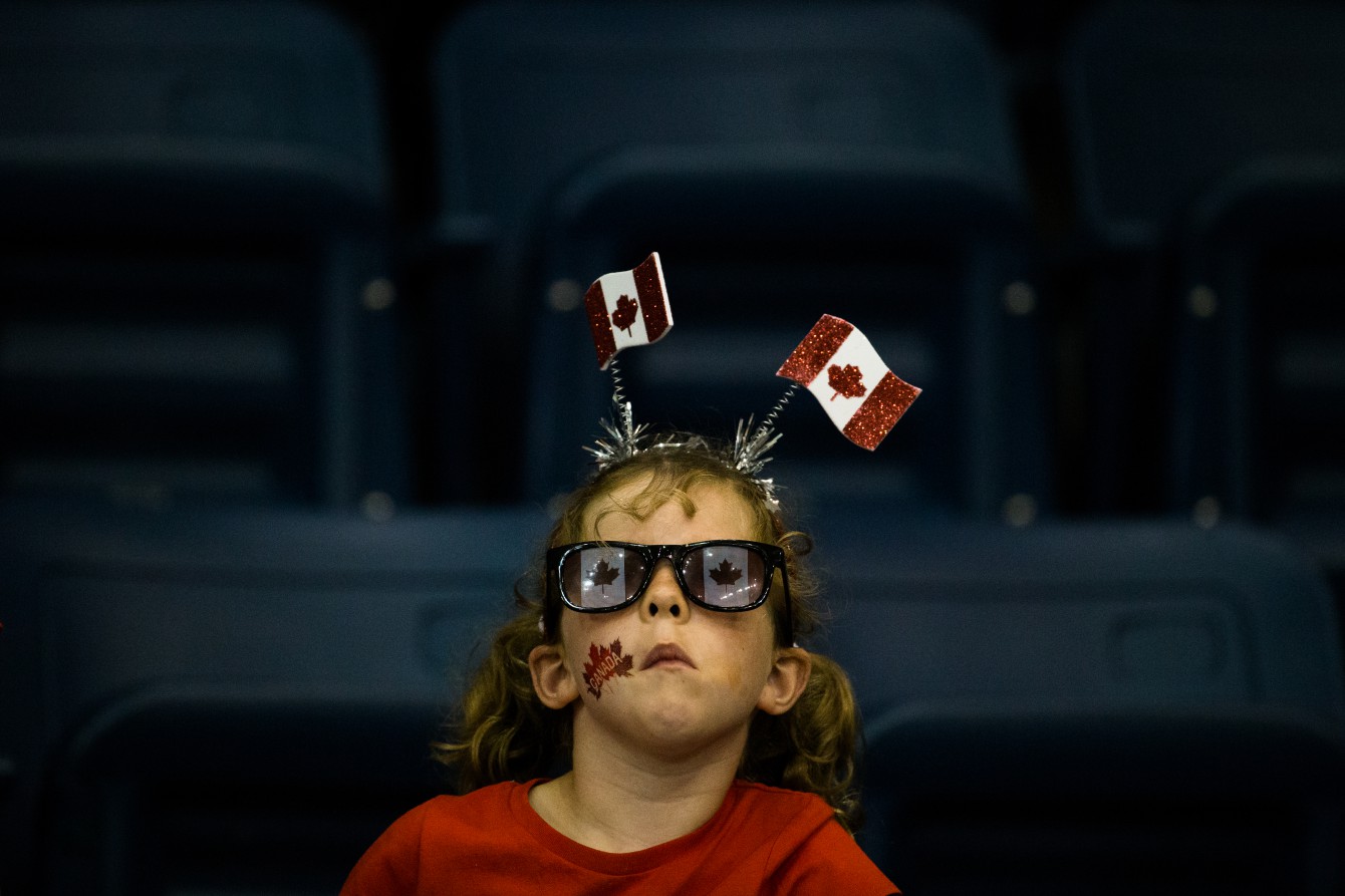 A girl supporting Team Canada is seen in the stands at Ryerson Athletic Centre in Toronto, during the Canada v. Argentina basketball game, July 17 2015 (John Fernandez for COC).
